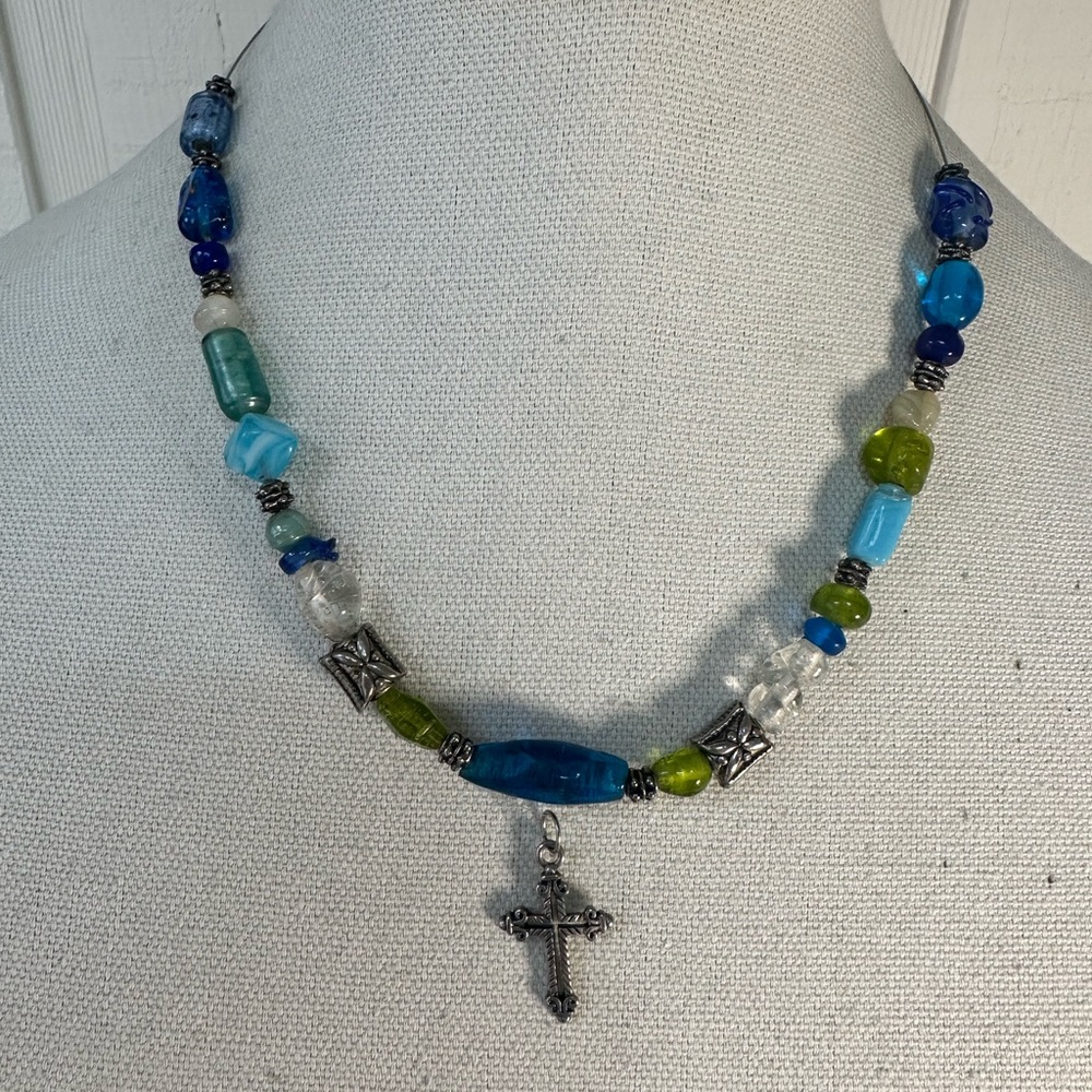 Blue and green glass bead necklace floating cross